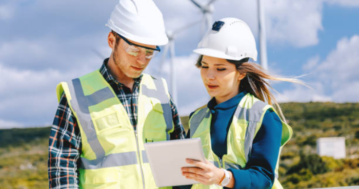 two sustainability workers with devices