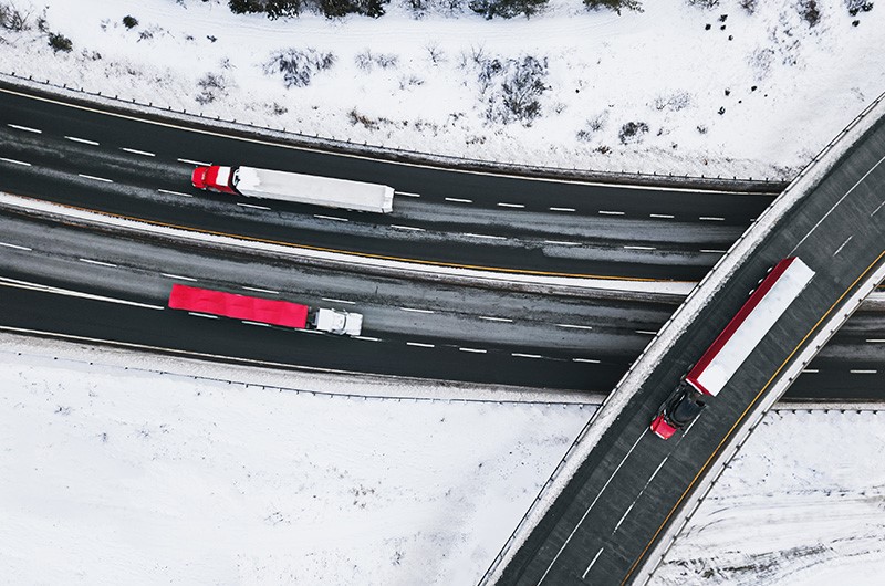 Three lorries on a snowy road