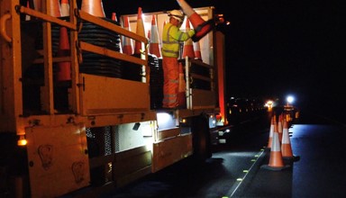 A Kier worker placing cones on the road