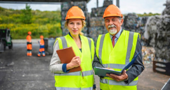 two workers with clipboards