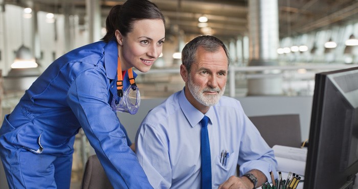 two workers using software