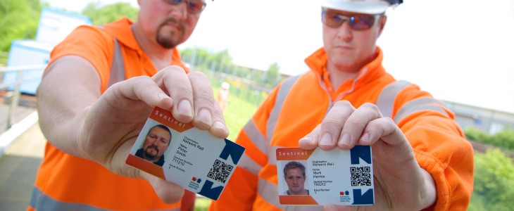 Two rail workers with smartcards