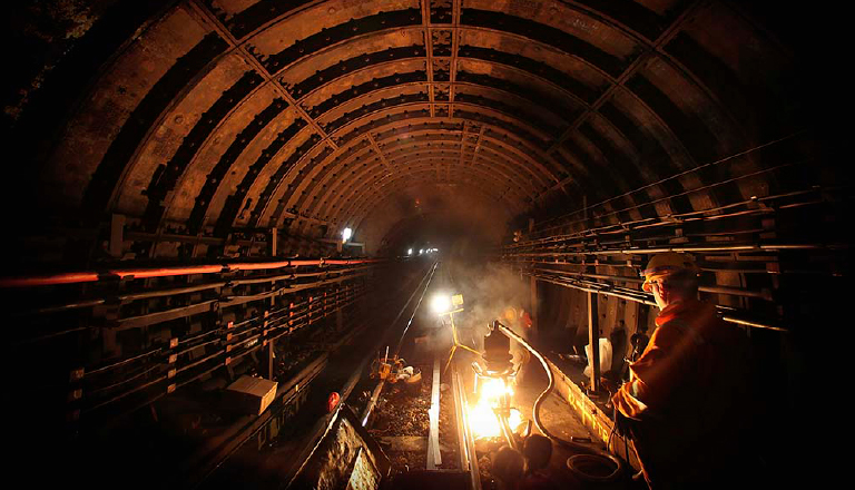 A rail worker in a tunnel